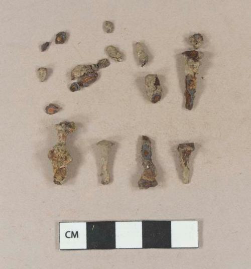 Cut or wrought iron tacks; iron fragments, likely originally from tacks