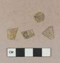 Yellow flat glass fragments, heavily patinated