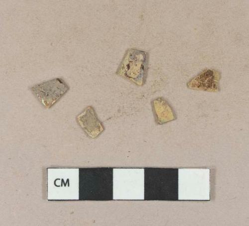 Yellow flat glass fragments, heavily patinated