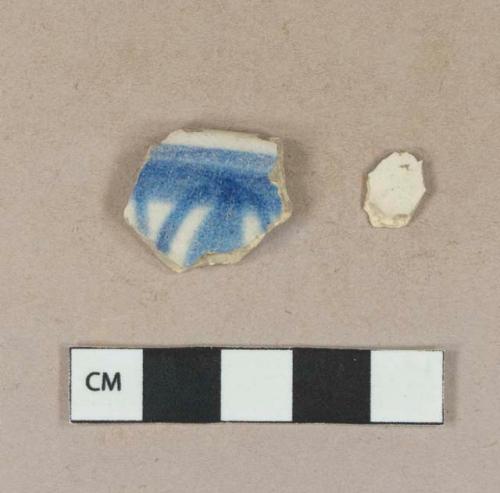 Blue hand painted tin glaze earthenware rim sherd; undecorated tin glaze earthenware body sherd