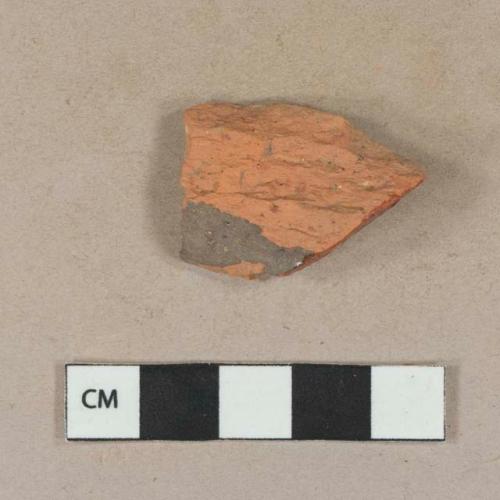 Undecorated lead glazed redware body sherd