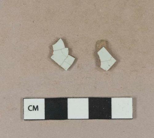 Red-bodied, undecorated tin glaze earthenware body sherds; two sherds crossmend