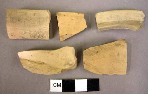 1 rim fragment, 1 handle fragment, 3 potsherds, all yellow minyan, wheel made