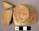 1 pottery foot fragment; 1 foot fragment (?); 1 cup fragment - plain, slipped wa