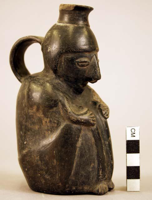 Pottery jar, handle on side, black, human form