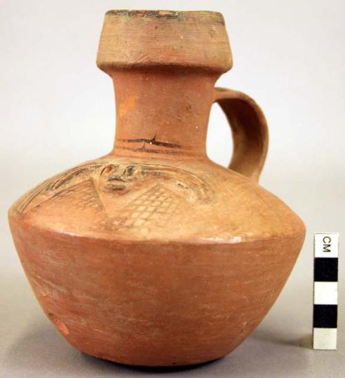 Pottery jar, handle on side, red, with incised ornament and painted