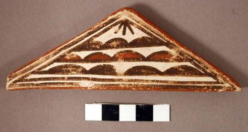 Triangular pottery tile; "Cloud emblems"