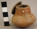 Miniature Brown Ware vessel with lid.  Incised lineal design.