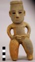 Hollow human effigy figure wearing loin cloth and carrying bag?