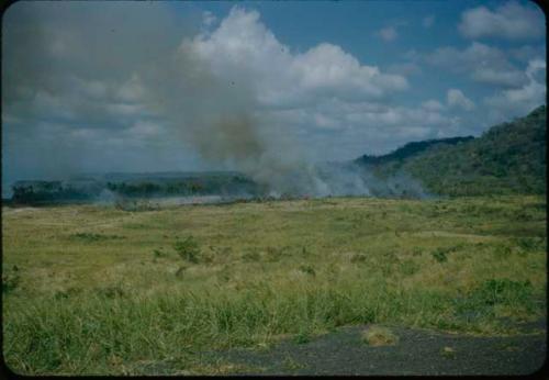 Landscape with burning grass, Area A in distance