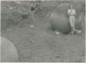 Dr. Doris Stone leaning on stone ball