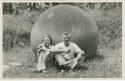 Dr. Doris Stone and Samuel K. Lothrop sitting against stone ball