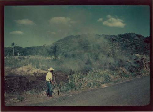 Burning grass near Area A, Trench 7, looking west