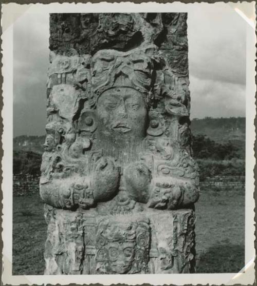 Closeup of head and torso area on an upright stela