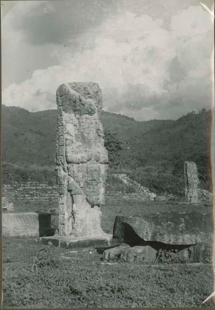 Upright stelae and stone objects in an open field