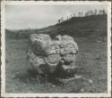 Stone sculpture in an open field