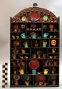 Glazed ceramic & metal miniature vessels in wooden shadow box