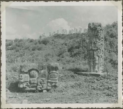 Upright stela and round stone sculpture