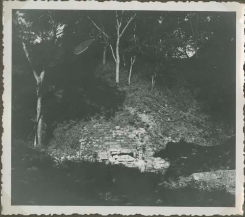 View at a distance of stone stairway with stela and sculpture