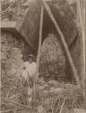 Local man with stone sculpture in vaulted stone archway