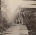 Woman and two girls in front of a house