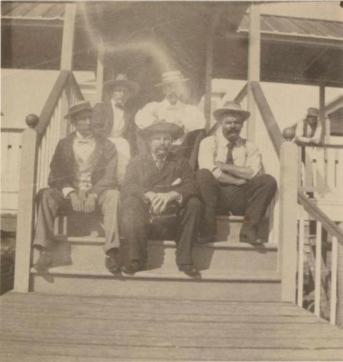 Group of men sitting on stairs