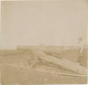 Woman standing next to a large cannon