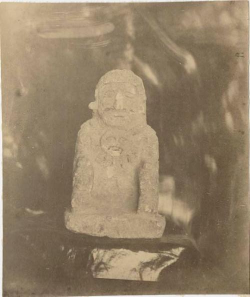 Seated stone figure