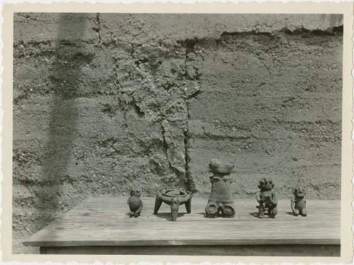 Tripod and four figurines