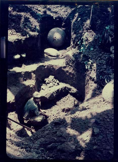 Man excavating unit with stone ball