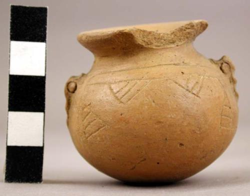 Miniture buff pottery vessel  flaring neck (broken); incised decoration