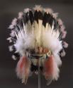 Beaded leather banded feathered headress, tipped with pink feathers