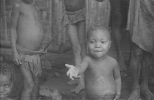 A young child, Padafan, asking for a balloon, part of a behavior sequence  of photos