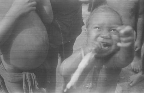 A young child, Padafan, begging for a balloon, part of a behavior sequence  of photos