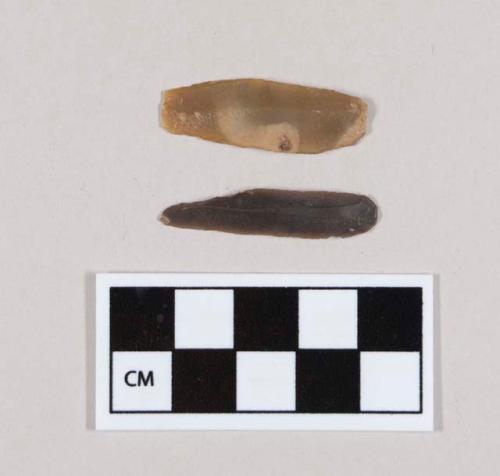 Flint bladelet; retouched point; black-colored stone