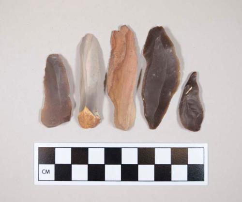 Chipped stone, blades, some cortex, tan, gray, brown, reddish in color