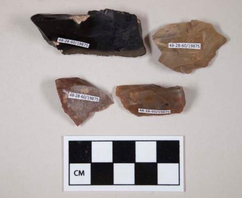 Chipped stone, burins?, some cortex, red, brown, black in color