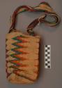 Woven agave fiber bag with shoulder strap; multicolor design on +