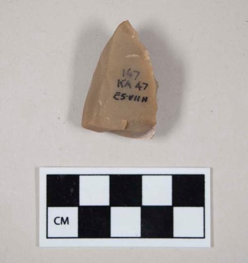 Chipped stone, edged tool, burin?, tan with some white at one corner