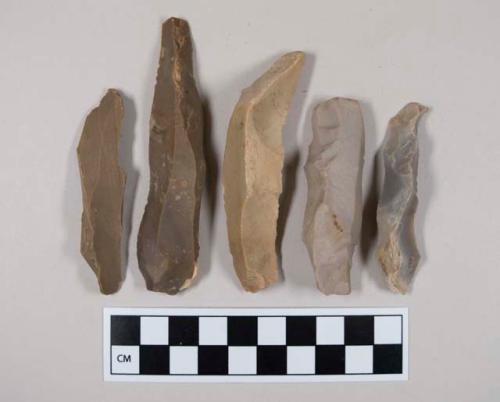 Chipped stone, flint blades, some with evidence of use or retouching