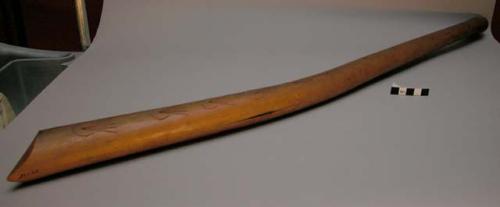 War club handle. Blade is missing. Slit down edge for blade. Carved designs
