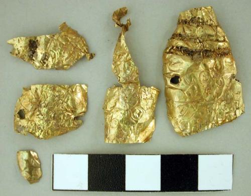 Fragments of thin gold plate with design