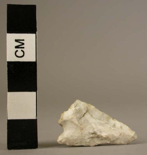 Tanged and barbed flint arrowhead with one barb and part of the tang broken off