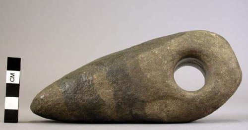 Typical crude stone axe or hoe, with hole for insertion of handle 17.2 cm.l. x 7