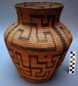 Medium-sized, jar-shaped utility basket, coiled.
