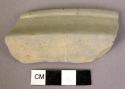 Rim sherd.  Notation on sherd "Fine grey.  Grater bowl"