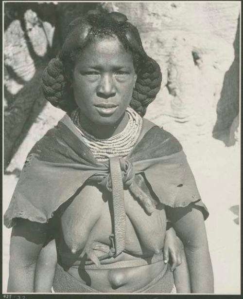 Woman standing in front of baobab tree (print is a cropped image)