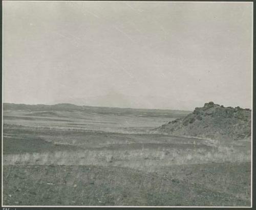 Hill, with hills and mountains in distance (print is a cropped image)