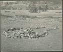 Pile of stones in circle with space for entrance (print is a cropped image)