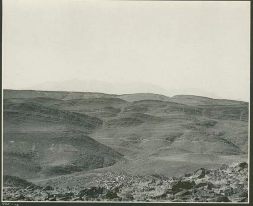 Hills, with mountains in distance (print is a cropped image)